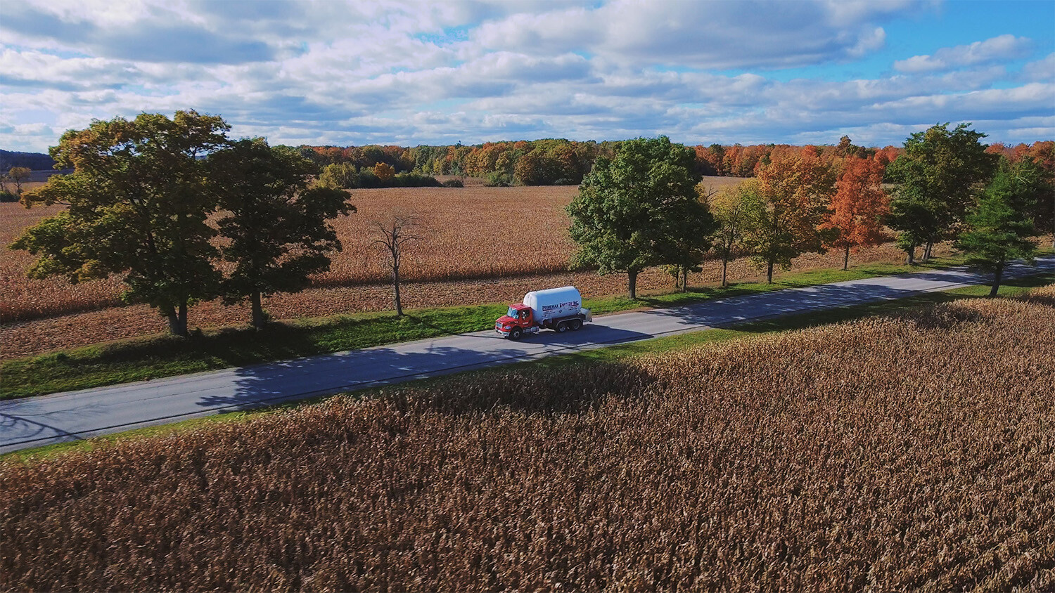 A Primemax Energy Propane Truck driving on a rural road.