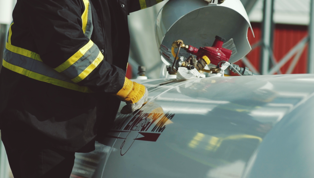 A Primemax Energy Employee opening a propane tank.